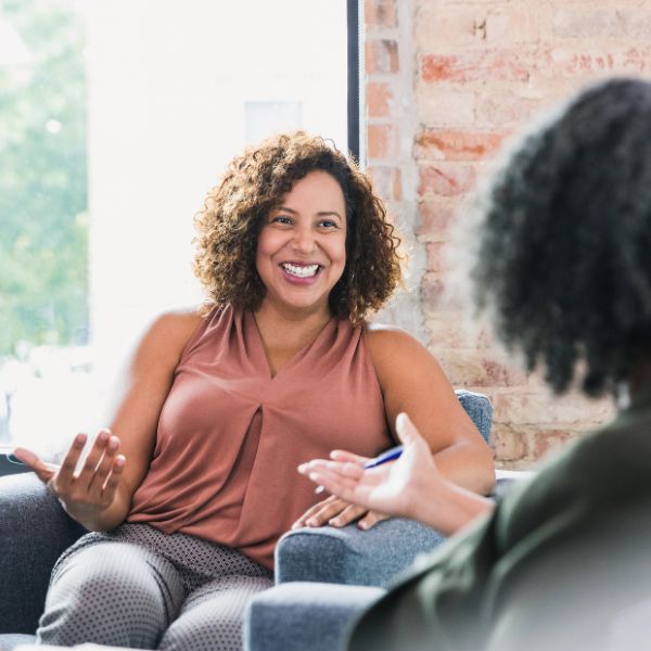A woman conversing while sitting on a couch